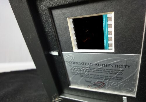 Certificate of authenticity with film strip in frame