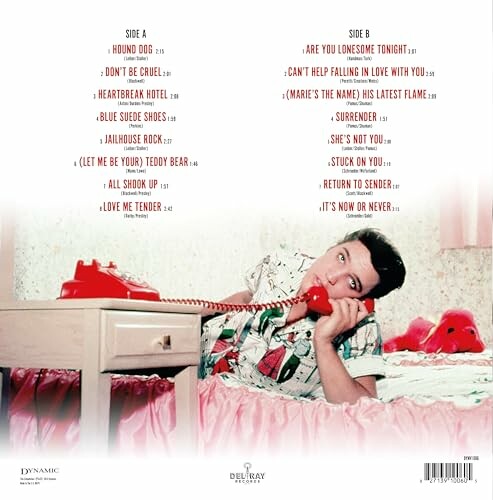 Person lying on bed with red phone, album track list displayed.