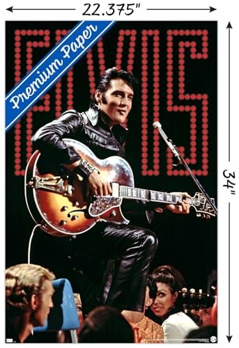 Elvis Presley performing with a guitar, wearing a black leather outfit.