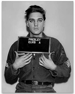 Black and white image of a person in military uniform holding a sign.